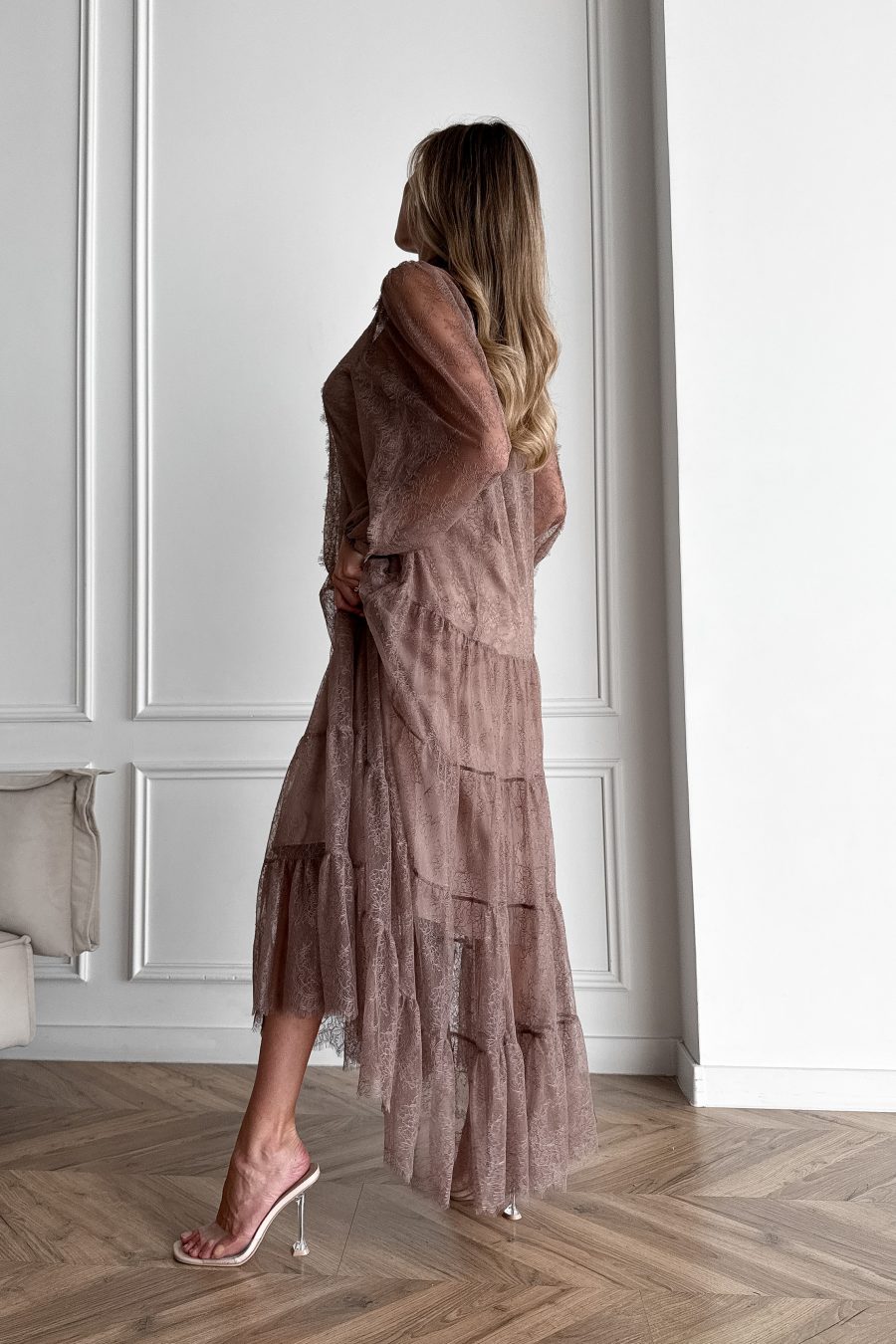 Lace long dress of a free silhouette, with a beige dress cover on straps