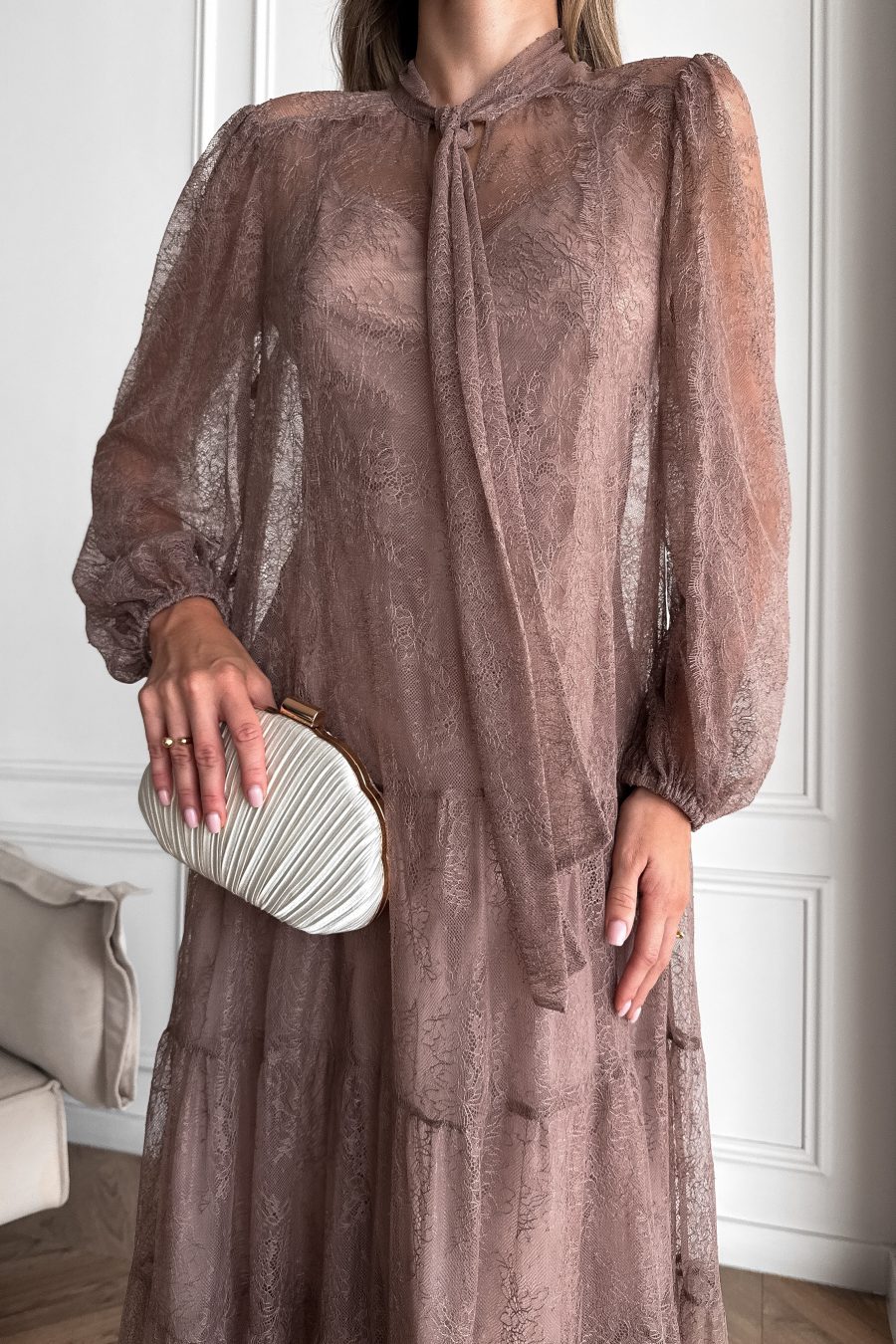 Lace long dress of a free silhouette, with a beige dress cover on straps