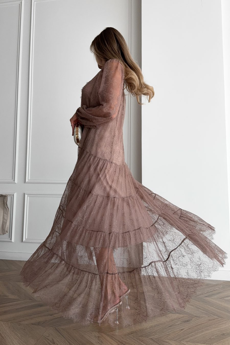 Lace long dress of a free silhouette, with a beige dress cover on straps