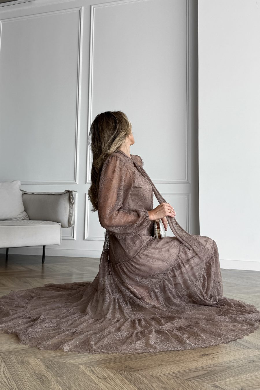 Lace long dress of a free silhouette, with a beige dress cover on straps