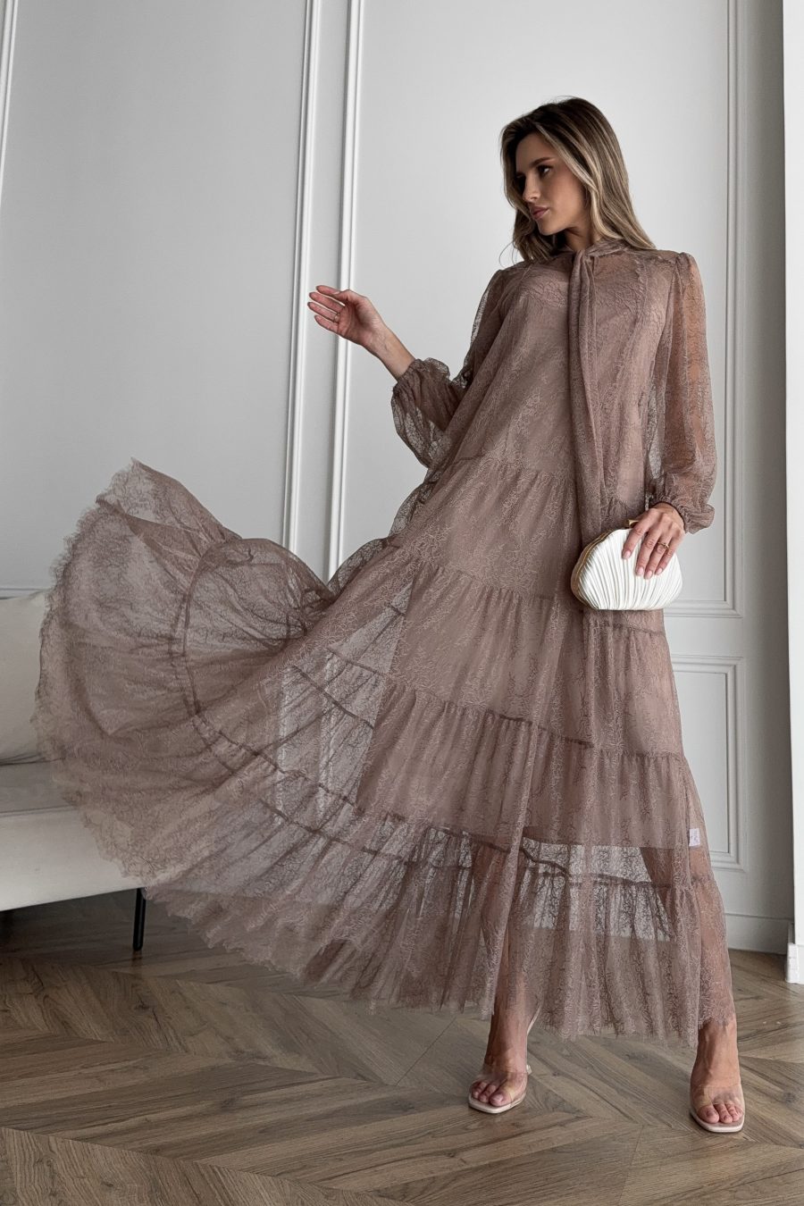 Lace long dress of a free silhouette, with a beige dress cover on straps