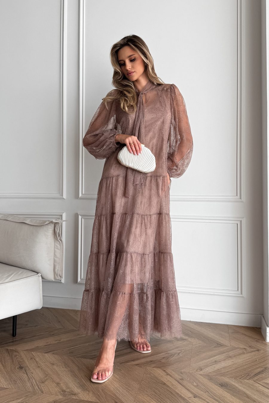 Lace long dress of a free silhouette, with a beige dress cover on straps