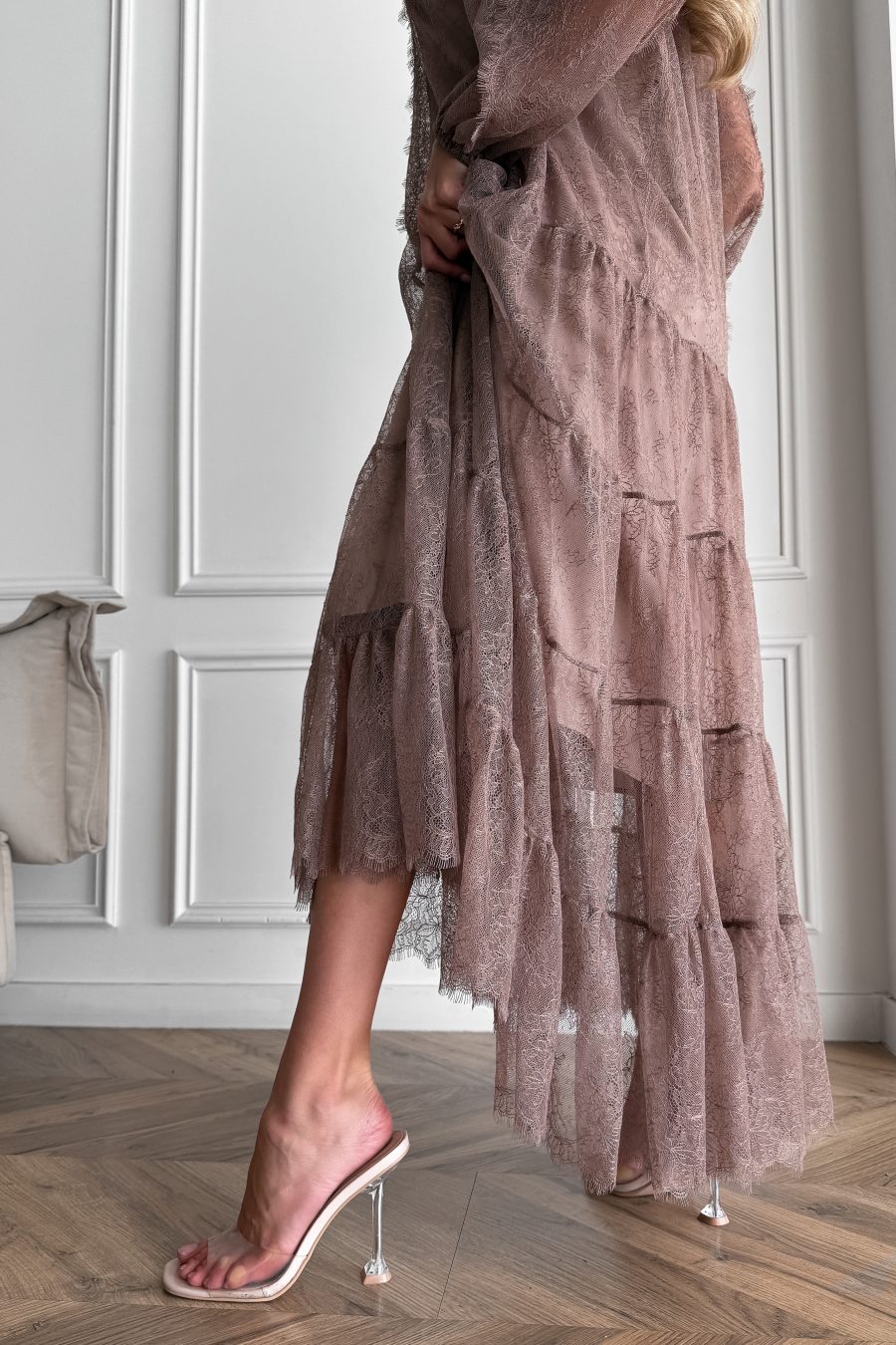 Lace long dress of a free silhouette, with a beige dress cover on straps